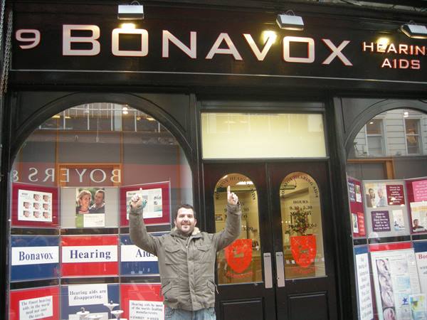 Man raising arms outside the Bonavox Hearing Aids shop in Dublin
