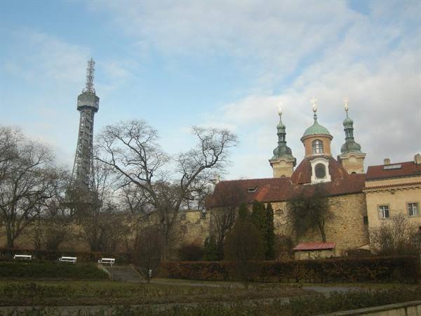 Petřín steel tower beside St Lawrence church, bare trees and benches
