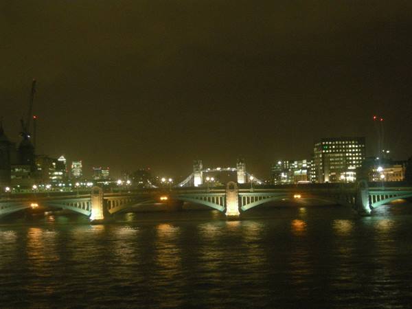 Illuminated Southwark Bridge over the Thames at night, Tower Bridge behind in London