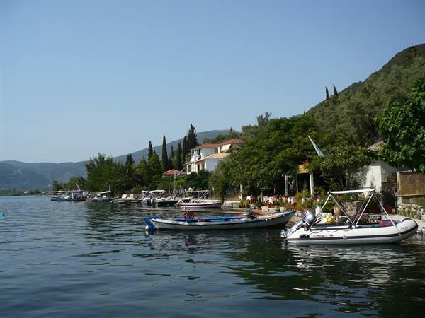 Fishing boats and dinghies moored beside tavernas and houses on the waterfront