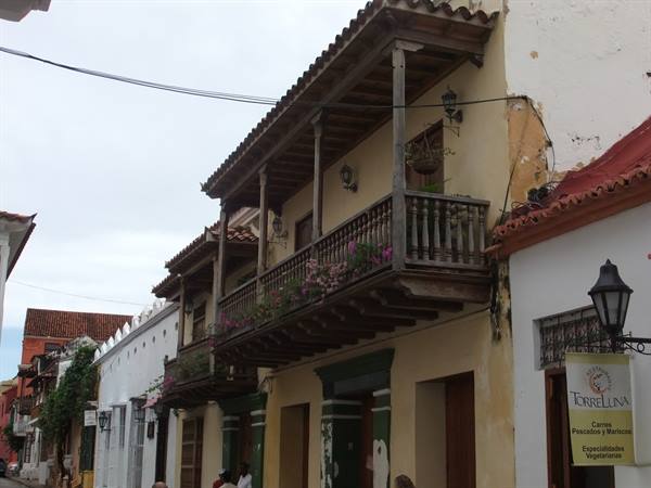 Wooden colonial balcony with flowers, Cartagena street, soft daylight