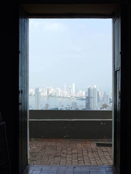 Through the doorway of La Popa convent, Cartagena's towers rise over the bay