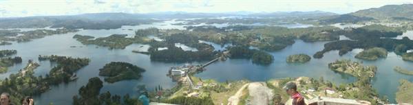 Tourists at the overlook above Guatapé lake, green islands in blue water
