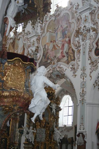 Marble angel statue inside the Wieskirche, rococo frescoes and gilded stucco