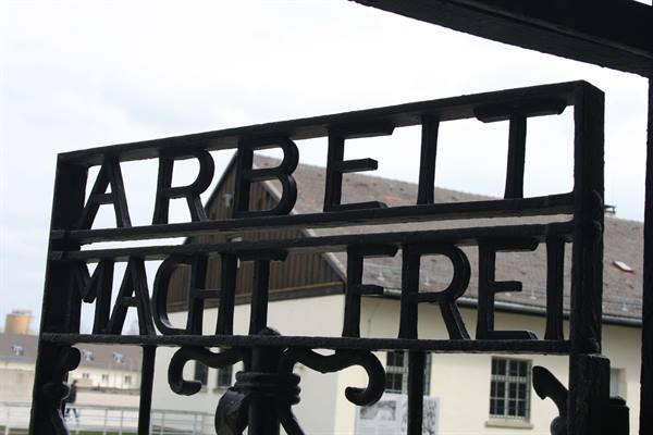 Iron gate with "Arbeit macht frei" inscription at Dachau