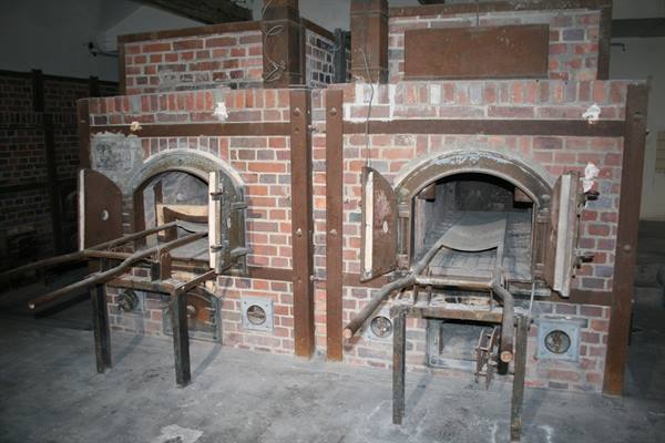 Red brick crematorium ovens with open metal doors, Dachau memorial