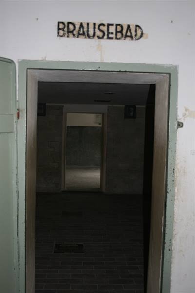 Dark shower room entrance with Brausebad sign above the door