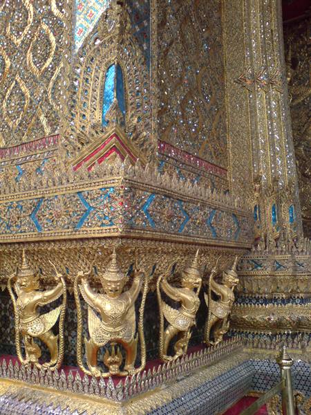 Gilded yaksha statues beneath blue enamel decorations, Wat Phra Kaew, Bangkok
