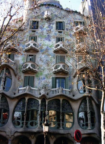 Gaudí's Casa Batlló trencadís facade in Barcelona, bone-like balconies under bare branches