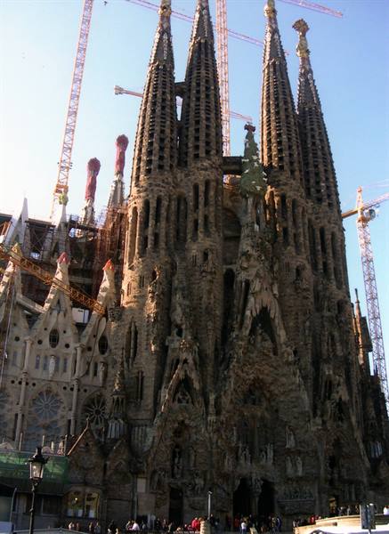 Sagrada Família in Barcelona, stone facade with cranes among the spires