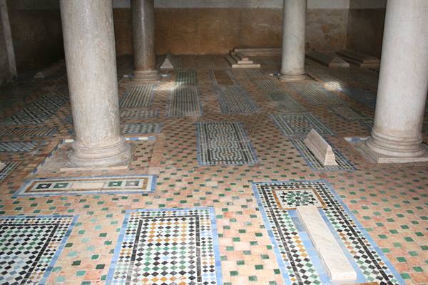 Marble columns and tombs with geometric zellige tiles, soft indoor light
