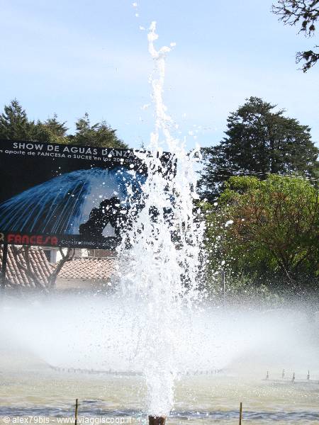 Tall water jet in park with dancing fountains show sign
