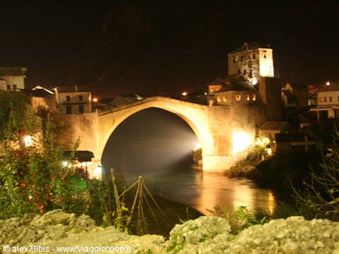 Mostar's Old Bridge illuminated at night over the Neretva river