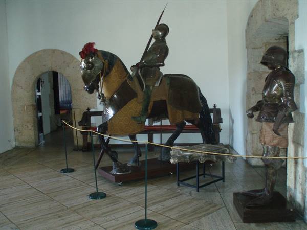 Mounted knight armor and foot armor displayed in museum hall
