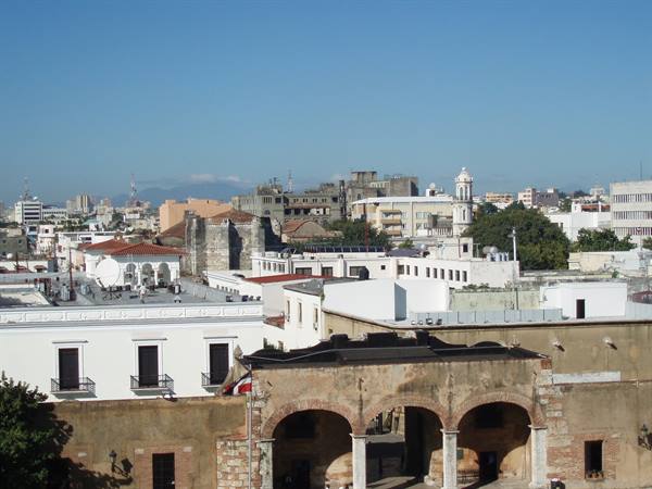 Colonial stone arches and white rooftops under the blue sky of Santo Domingo