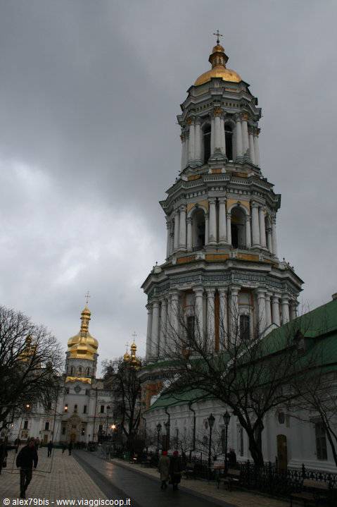 Baroque bell tower with golden dome at Kyiv Lavra under grey sky