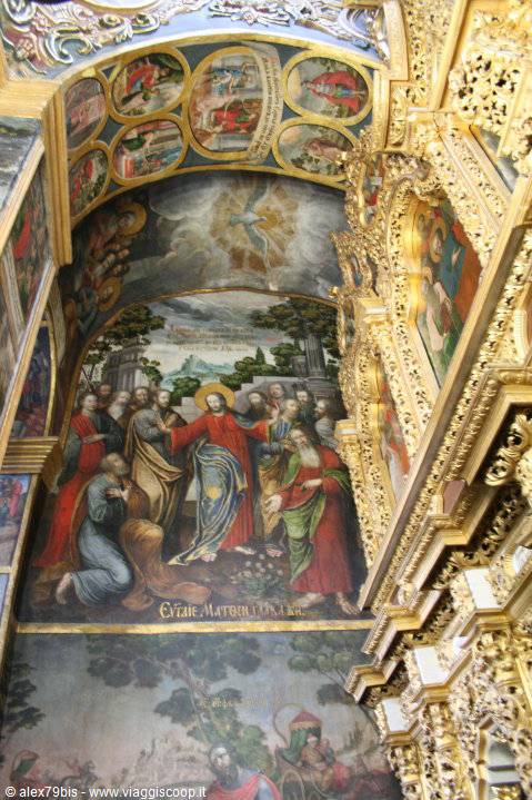 Fresco of Christ among apostles inside gilded iconostasis in Orthodox church