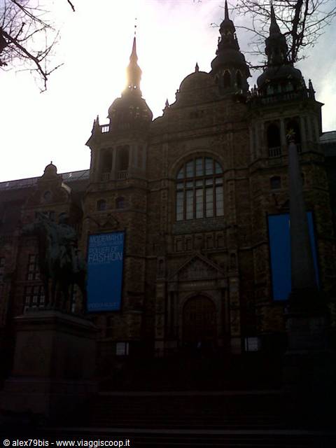 Brick facade of the Nordic Museum in Stockholm with spires and statues against the sky