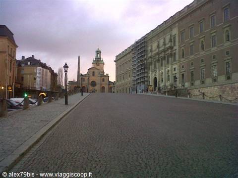 Cobbled square in Stockholm: the Royal Palace and Storkyrkan church under a grey sky