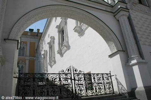 Wrought iron gate beneath the carved white arch of the Kremlin