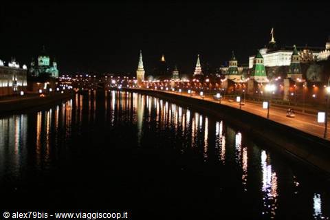 Kremlin towers lit at night reflecting in the Moskva River