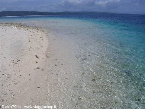White sand and clear turquoise water on a deserted tropical beach