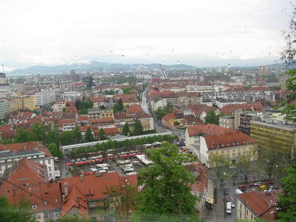 Ljubljana: red rooftops and covered market seen from castle hill in the rain