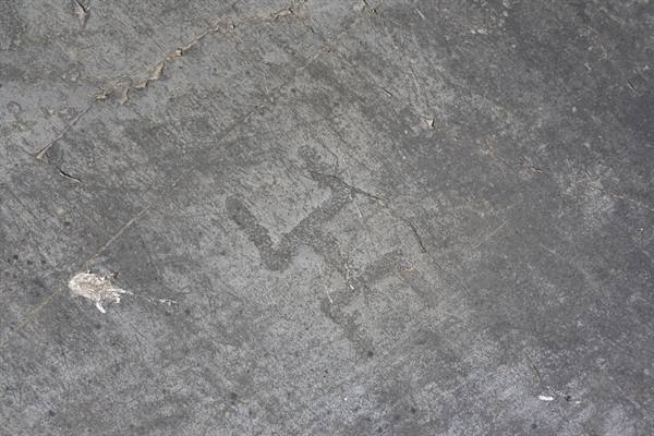Zigzag rock carving etched into the grey stone surface