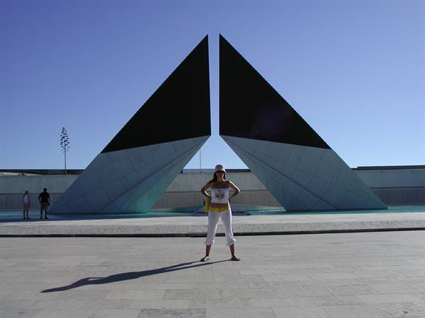 Tourist posing in front of the Monumento aos Combatentes do Ultramar, Lisbon