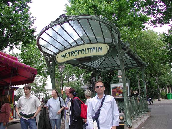 Tourists in front of the Art Nouveau Métropolitain subway entrance in Paris