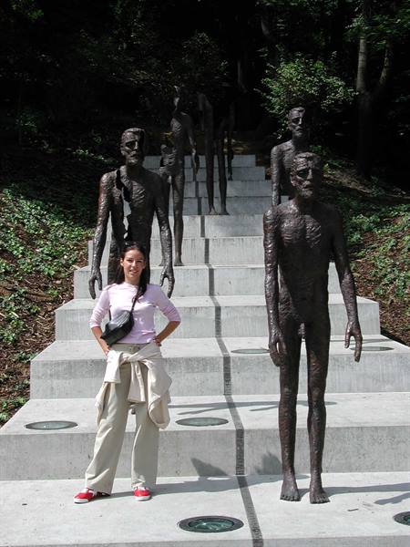 Woman beside bronze figures on the Memorial to the Victims of Communism staircase, Prague