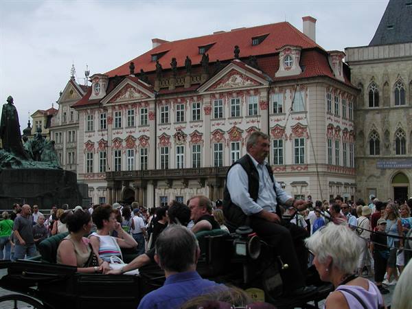 Tourists in a horse-drawn carriage on Prague's Old Town Square