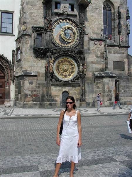 Woman in white dress in front of Prague Astronomical Clock