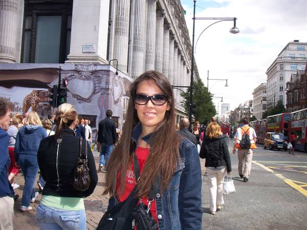 Girl in denim jacket and sunglasses on Oxford Street, London
