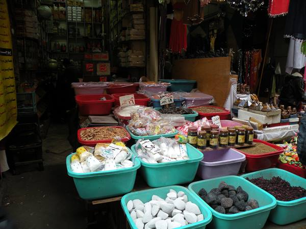 Plastic basins with sweets, dried fruit and honey in the covered bazaar