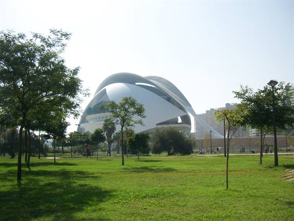 City of Arts and Sciences in Valencia, white curved building among trees and green lawn