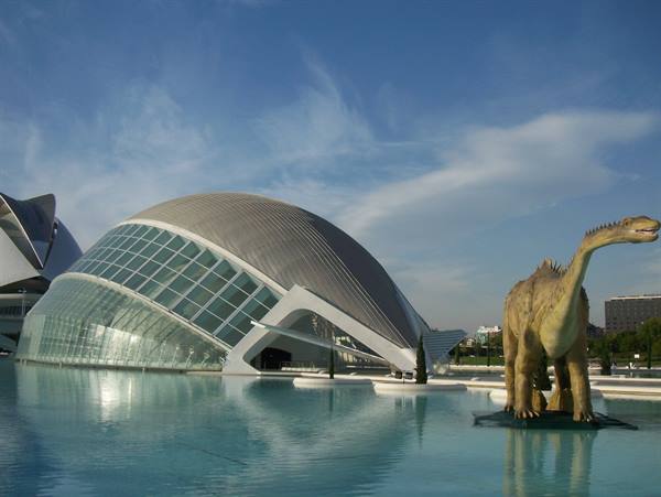 L'Hemisfèric at Ciudad de las Artes y las Ciencias with dinosaur statue on the water
