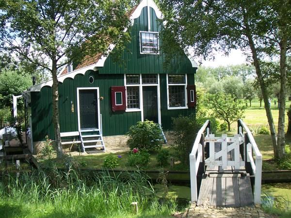 Green wooden house with white bridge over canal, Zaanse Schans