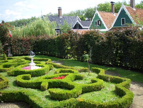 Formal boxwood garden with green wooden houses, Zaanse Schans