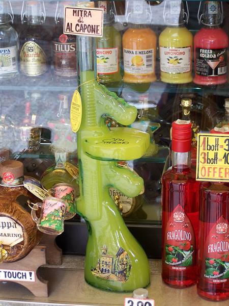 Green liquor bottle shaped like a machine gun in a souvenir shop window