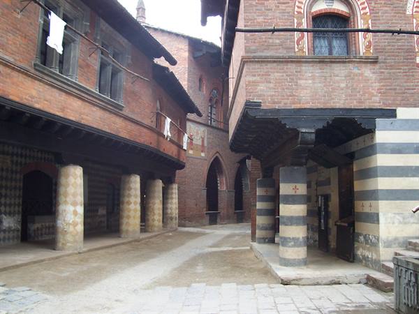 Courtyard of Turin's Borgo Medievale, brick houses with painted columns
