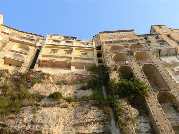 Old colorful houses built on the rock with arches and balconies