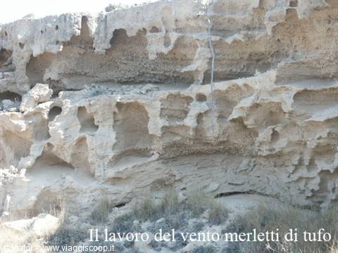Wind-eroded volcanic tuff rock in Milos, sunlight on the hollows