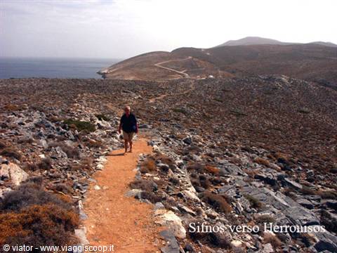 Walker on rocky dirt path toward Herronissos, Sifnos