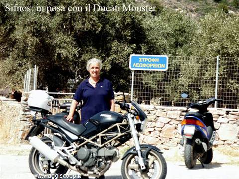 Sifnos: woman posing beside a black Ducati Monster, scooter parked nearby