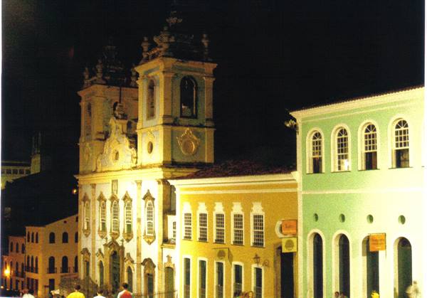 Baroque church lit at night in Pelourinho, colorful colonial facades