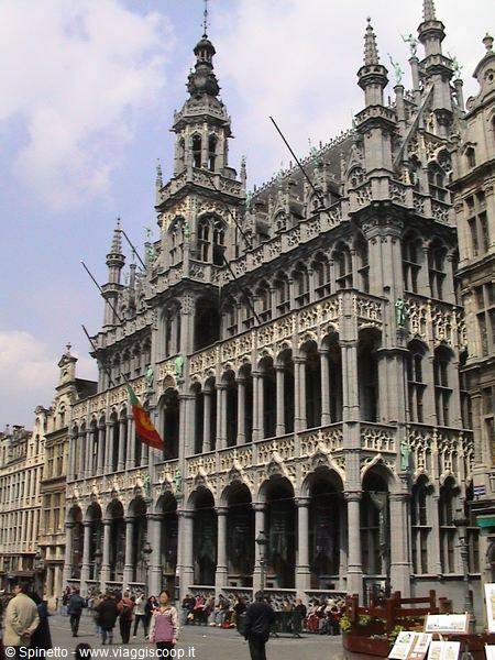 The stone Gothic Maison du Roi on Brussels' Grand-Place, tourists beneath the arcades