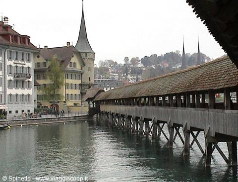 Wooden Kapellbrücke bridge over the river in Lucerne, octagonal tower
