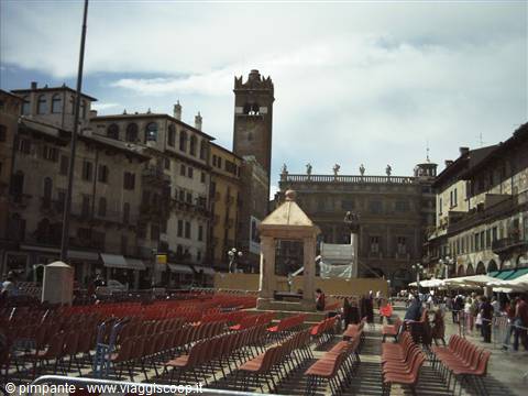 Piazza delle Erbe in Verona: rows of red chairs, tower in the background