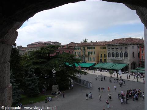 Piazza Bra in Verona seen from the Arena arch, tourists under green awnings